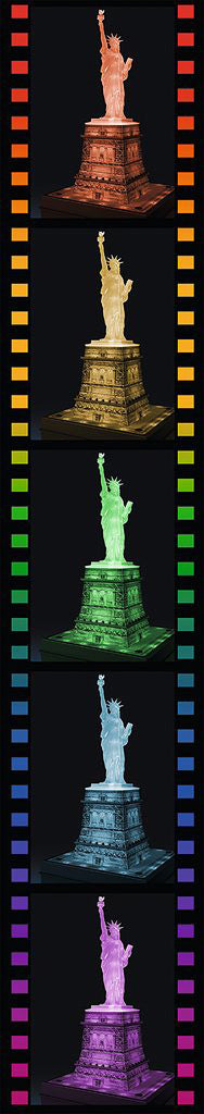 A vibrant design showcasing the Statue of Liberty in various illuminated colors against a dark background. The jigsaw puzzle captures the iconic statue's detail and grandeur, providing an engaging visual experience for puzzle enthusiasts.
