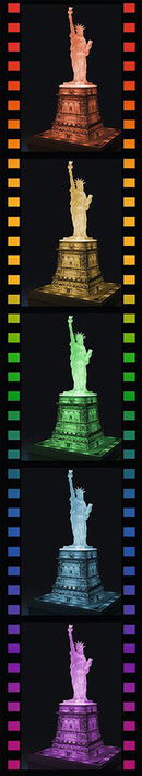 A vibrant design showcasing the Statue of Liberty in various illuminated colors against a dark background. The jigsaw puzzle captures the iconic statue's detail and grandeur, providing an engaging visual experience for puzzle enthusiasts.