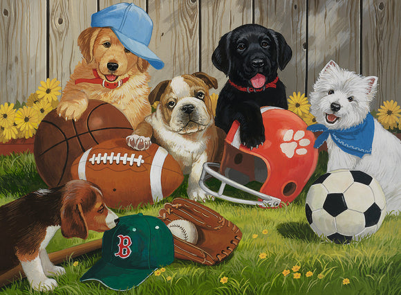 A colorful jigsaw puzzle featuring playful puppies surrounded by various sports equipment. The scene includes a golden retriever wearing a blue cap, a bulldog, a black labrador, and a small white dog with a blue bandana. They are playing with a football, a basketball, a baseball glove, and a soccer ball, set against a backdrop of a wooden fence and flowers.