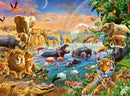 A vibrant jigsaw puzzle featuring a savannah waterhole scene bursting with wildlife. Elephants, giraffes, lions, and tigers gather around a sparkling blue waterhole. Flamingos stand gracefully on the water's edge, while zebras, hippos, and various birds populate the lush, colorful landscape. The background showcases a rainbow and a sunset, enhancing the exotic atmosphere of the African wilderness.