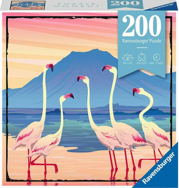 Ravensburger jigsaw puzzle titled 'Tanzania' featuring a vibrant illustration of five flamingos standing in shallow water against a backdrop of a pink and orange sunset with a mountain silhouette in the distance. The puzzle contains 200 pieces and emphasizes relaxation and enjoyable moments.