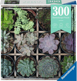 Ravensburger puzzle featuring a vibrant arrangement of 300 succulent plants displayed in small pots. A variety of colors and shapes are evident, enhancing the visual appeal. The box is labeled with '300 Ravensburger Puzzle' and emphasizes relaxation and enjoyment.