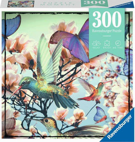 Ravensburger 300-piece jigsaw puzzle titled 'Hummingbird', featuring colorful illustrations of hummingbirds and butterflies among pink flowers, ideal for relaxation and enjoyment.
