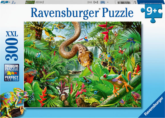 Ravensburger Reptile Resort Jigsaw Puzzle featuring a vibrant jungle scene filled with various reptiles, amphibians, and exotic flora. The puzzle contains 300 pieces and is designed for ages 9 and up, showcasing a detailed illustration of colorful chameleons, frogs, butterflies, and a snake coiled among the lush greenery.