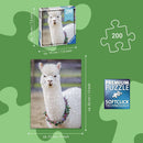 Puzzle Moments: Alpaca jigsaw puzzle featuring a charming image of a white alpaca wearing a floral necklace. The puzzle has 200 pieces, dimensions of 21 cm by 33 cm, and is created with Ravensburger's Softclick technology for a seamless fit. The box dimensions are 19 cm by 19 cm. Ideal for puzzle lovers and alpaca enthusiasts.