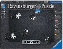 Ravensburger Krypt Jigsaw Puzzle box showcasing a unique spiral design featuring black puzzle pieces. The box includes details about the challenge of assembling the puzzle without a reference image, highlighting its difficulty and the use of Softclick technology for easy piece connection.
