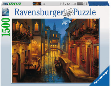 A beautifully illustrated jigsaw puzzle featuring the serene canals of Venice at dusk, showcasing picturesque buildings with balconies adorned with flowers and a gondola drifting quietly through the water. The Ravensburger box displays the puzzle's title 'Waters of Venice' along with the total piece count of 1500, emphasizing the premium quality and intricate design.
