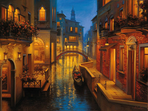 A serene canal scene in Venice illuminated by warm, enchanting lights at dusk. The image features classic Venetian architecture, a quaint bridge, and a gondola gliding smoothly along the shimmering water, creating a tranquil ambiance for a jigsaw puzzle titled 'Waters of Venice' by Ravensburger.