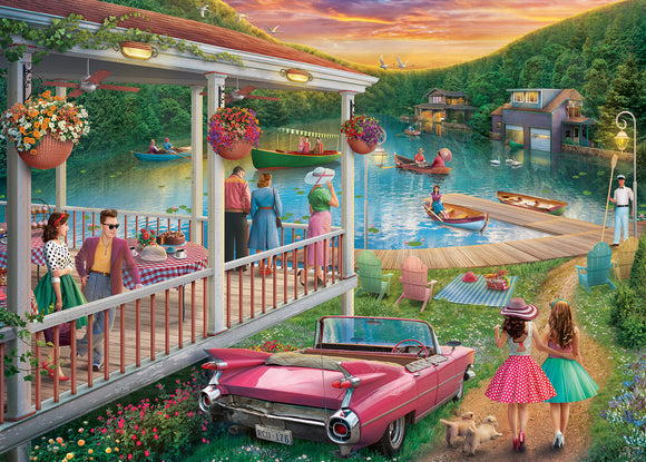 A vibrant jigsaw puzzle titled 'Summer at the Lake' by Ravensburger shows a picturesque lakeside scene. It features a charming wooden deck adorned with hanging flower baskets, a classic pink convertible parked on lush grass, and groups of people enjoying the serene setting. Colorful boats gently glide across the water, while families and friends engage in leisurely activities, embodying the nostalgic charm of summer.