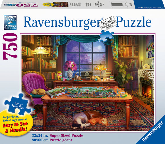 Puzzler's Place Jigsaw Puzzle by Ravensburger featuring a cozy indoor scene with a colorful puzzle spread out on a wooden table. Surrounded by a purple chair, cats lounging, bookshelves, and a warm fireplace, this 750-piece puzzle showcases vibrant colors and intricate details, perfect for puzzle enthusiasts.
