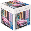 Ravensburger jigsaw puzzle titled 'Cuba', featuring a vibrant illustration of a classic pink car parked in a colorful street with colonial-style buildings. The puzzle package displays the image on multiple sides and indicates it contains 99 pieces, perfect for puzzle enthusiasts and collectors.