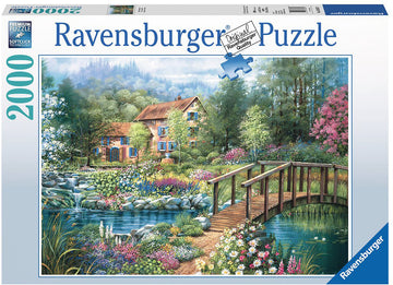Ravensburger jigsaw puzzle titled 'Shades of Summer', featuring a picturesque scene with a charming house, a wooden bridge, and a vibrant garden filled with blooming flowers, set against a serene landscape of trees and a flowing stream. This 2000-piece puzzle showcases beautiful colors and details, perfect for puzzle enthusiasts.