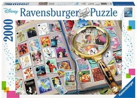 Disney stamp album jigsaw puzzle by Ravensburger featuring 2000 pieces. The image shows a colorful assortment of Disney character stamps laid out in an album beside a magnifying glass, capturing the essence of beloved characters like Elsa, Mickey Mouse, and Winnie the Pooh.