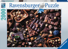 A Ravensburger jigsaw puzzle titled 'Chocolate Paradise' featuring an aerial view of various types of chocolate, nuts, and dried fruits artfully arranged on a wooden table. The puzzle box displays vibrant imagery of the delicious assortment, promising a delightful and challenging experience for puzzle enthusiasts.