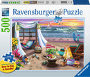 A vibrant Ravensburger jigsaw puzzle depicting a serene seaside retreat. The image features a cozy beach scene with a hammock, colorful flowers, a table set with snacks, lounge chairs, and surfboards near a scenic ocean view. The sky is painted with warm sunset colors, adding a peaceful ambiance to the puzzle.