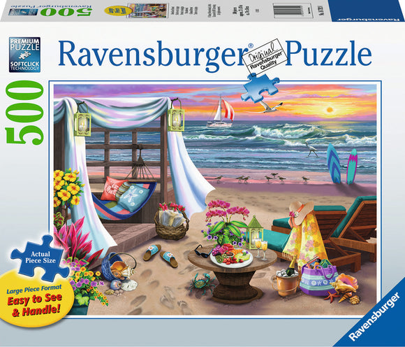 A vibrant Ravensburger jigsaw puzzle depicting a serene seaside retreat. The image features a cozy beach scene with a hammock, colorful flowers, a table set with snacks, lounge chairs, and surfboards near a scenic ocean view. The sky is painted with warm sunset colors, adding a peaceful ambiance to the puzzle.