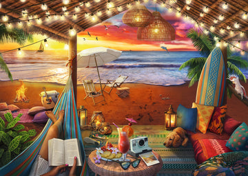 A vibrant jigsaw puzzle illustration titled 'Cozy Cabana' by Ravensburger, depicting a serene beach scene. The image features a hammock with a person reading, surrounded by lush greenery, colorful cushions, and a beach setting with a campfire, surfboards, and beach chairs. A stunning sunset casts warm colors over the ocean, enhancing the tranquil vibe.