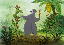 The Disney Vault: Baloo jigsaw puzzle features the iconic bear Baloo surrounded by lush tropical vegetation and vibrant plants. Baloo joyfully holds fruit and stands in a lively jungle setting, capturing a delightful moment from Disney's classic animation.