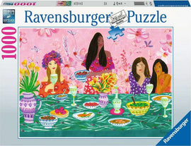 A colorful Ravensburger jigsaw puzzle featuring a ladies' brunch scene. Four women dressed in vibrant outfits enjoy a table filled with food and drinks, surrounded by flowers and decorative tableware. The design is lively and beautifully illustrated, capturing a joyful gathering.