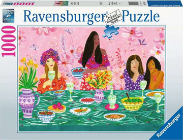 A colorful Ravensburger jigsaw puzzle featuring a ladies' brunch scene. Four women dressed in vibrant outfits enjoy a table filled with food and drinks, surrounded by flowers and decorative tableware. The design is lively and beautifully illustrated, capturing a joyful gathering.