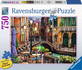 Ravensburger Venice Twilight jigsaw puzzle featuring a beautiful scene of a canal in Venice. The artwork shows colorful buildings, a bridge, and outdoor café tables adorned with flowers. The puzzle includes 750 large pieces designed for easy handling.