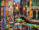 A vibrant jigsaw puzzle featuring a picturesque Venice scene at twilight. The image showcases a charming canal, elegant buildings with colorful facades, street lamps illuminating the walkway, and outdoor café tables adorned with flowers. A small bridge crosses over the canal, reflecting the stunning colors of the evening sky, inviting viewers into a serene, romantic atmosphere.