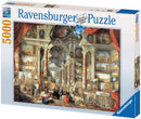 A jigsaw puzzle box featuring 'Views of Modern Rome' by Ravensburger. The design showcases a detailed artwork filled with classical architecture and scenes of Rome, including columns, statues, and people engaged with the art. The box includes a vibrant illustration of the completed puzzle, emphasizing its intricate design and rich details, suitable for puzzle enthusiasts and lovers of art.