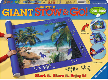 The Giant Puzzle Stow & Go! by Ravensburger features a vibrant jigsaw puzzle scene of a tropical beach with palm trees and sandy shore. It includes a blue mat and an inflatable tube to easily roll and store puzzles ranging from 1000 to 3000 pieces. The mat is shown with scattered puzzle pieces around it, highlighting its practical design for puzzle enthusiasts.