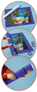 The Giant Puzzle Stow & Go! by Ravensburger is shown in a series of steps. The jigsaw puzzle is displayed on a mat with a tropical beach scene. Images show how to roll the mat for easy storage and features individuals holding the rolled mat securely. The mat is blue with an outline, and accessories like elastic bands are included for securing the rolled puzzle.