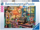 The Sewing Shed jigsaw puzzle by Ravensburger features a cozy sewing space filled with colorful fabrics, a vintage sewing machine, and charming decorations. The scene includes a warm lamp, a wooden table with various crafting supplies, and adorable animals, all set against a large window revealing a sunny garden view. This 1000-piece puzzle promises hours of enjoyable assembly and delightful details.