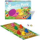 Snail's Pace Race game by Ravensburger, featuring colorful snail figurines in red, yellow, green, blue, pink, and orange on a vibrant game board. The game box showcases cheerful illustrations of snails racing and playful animals in a bright, outdoor setting. Includes two dice for gameplay.