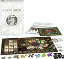 Carpe Diem board game by Ravensburger displayed with its box, game board, player pieces, and various tokens and cards. The game setup includes colorful player pieces in green, yellow, red, and blue, surrounded by tiles and scoring components, showcasing a strategic layout for players.