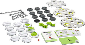 GraviTrax: The Game Flow by Ravensburger, featuring a variety of colorful game pieces including hexagonal tiles, rails, and a guidebook, designed for creating dynamic marble runs. The components are arranged on a white background, showcasing different shapes and colors that facilitate engaging gameplay and stimulating creativity.
