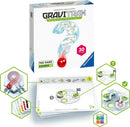 GraviTrax: The Game Course by Ravensburger, featuring an interactive track system designed to explore the power of gravity. The package includes 30 challenges with illustrated game cards showing various track designs and components. A red marble is shown rolling down a track, accompanied by visual aids for players to understand the gameplay.