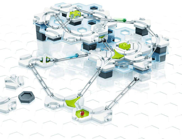 The GraviTrax Starter Set by Ravensburger, featuring a modular marble run design with various track pieces and connectors laid out on a hexagonal grid. The set includes vibrant green and blue elements, allowing for endless possibilities in building tracks that guide marbles through a network of paths. Ideal for encouraging STEM learning and creativity in kids.