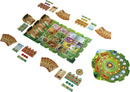 A colorful board game titled 'Meadow' by Rebel, featuring a vibrant illustrated game board with various cards, tokens, and pieces arranged around it. The board displays lush landscapes with illustrations of flora and fauna, along with several other game components including player boards and scoring tokens. This engaging game is perfect for family and friends.