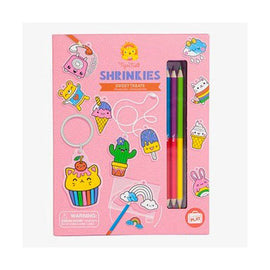 A colorful DIY kit called Sweat Treats Shrinkies by Tiger Tribe. The kit includes vibrant colored pencils and plastic sheets with pre-printed designs like cute food characters, ice cream, and playful accessories. Ideal for creative crafting, allowing kids to design and shrink their own unique keychains and charms.