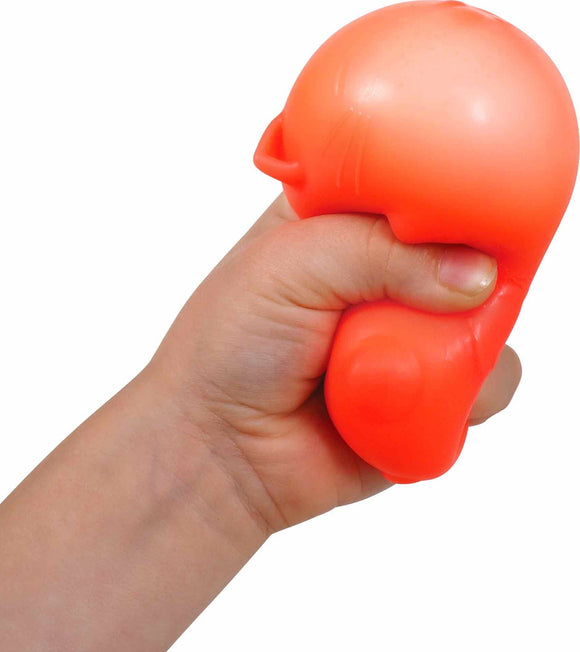 A child’s hand squeezing a soft, orange cat-shaped stress toy, featuring rounded edges and a simple design. The toy is designed for stress relief and sensory play.