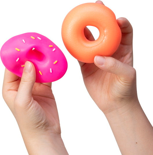 Two colorful NeeDoh Dohnuts in hands. One is a pink donut with colorful sprinkles, while the other is a smooth orange donut. These fidget toys provide sensory pleasure and stress relief.
