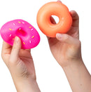 Two colorful NeeDoh Dohnuts in hands. One is a pink donut with colorful sprinkles, while the other is a smooth orange donut. These fidget toys provide sensory pleasure and stress relief.