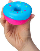 A person holding a colorful NeeDoh Dohnuts fidget toy shaped like a donut. The toy has a bright blue top with colorful sprinkles and a pink bottom.