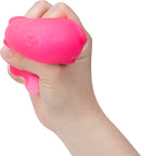 A hand squeezing a bright pink NeeDoh Funky Pup stress ball, shaped like a cute dog. The Puffy Pup is designed for stress relief and sensory play, featuring a soft, squishy texture that makes it fun and soothing to squeeze.