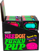 A display box showing multiple NeeDoh Funky Pups in vibrant colors including pink and teal. Each pup features playful text inviting users to squish, stretch, and pet them. The packaging is colorful and designed to attract attention, showcasing the fun and sensory nature of these toy items by Schylling.