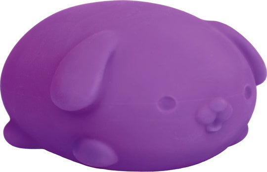 A NeeDoh Funky Pup from Schylling, featuring a cute, purple, squishy dog toy designed for stress relief and sensory play. The toy has a smooth surface and a rounded shape, resembling a chubby puppy with floppy ears.