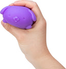 A hand squeezing a small, purple puppy-shaped stress ball. The stress ball has round ears, a snout, and a smooth texture, designed for fidgeting and relaxation.
