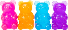 A colorful assortment of Needoh Gummy Bear fidget toys, featuring four gummy bear figures in vibrant shades of pink, orange, blue, and purple. Each plush-like bear has a smooth, squishy texture that's perfect for sensory play and stress relief.