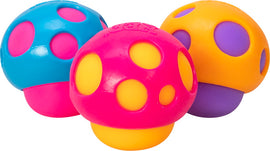 A colorful set of three Needoh Groovy Shrooms by Schylling, featuring a pink mushroom with yellow and purple dots, a blue mushroom with pink dots, and an orange mushroom with purple dots. Each mushroom is designed as a squishy fidget toy, perfect for sensory play and stress relief.