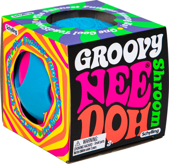 The Needoh Groovy Shroom by Schylling features a playful, colorful design with a bright blue and pink mushroom shape. The packaging showcases vibrant psychedelic patterns and bold text, highlighting that it’s a fun, stress-relieving fidget toy suitable for all ages. A warning label about small parts is included, indicating it's not for children under 3 years.