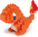 A vibrant Nanoblock DIY kit featuring a small, intricately designed model of Charmander, the fire-type Pokémon. The model is predominantly orange with a yellow and red flame on its tail, showcasing detailed block construction.