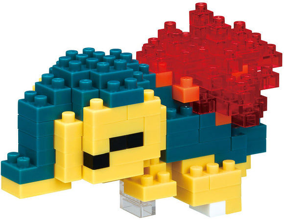 Nanoblock Cyndaquil DIY kit featuring colorful blocks to create the iconic Pokémon character. The assembled model showcases Cyndaquil's distinctive features, including its blue and yellow body and vibrant red flame spines.